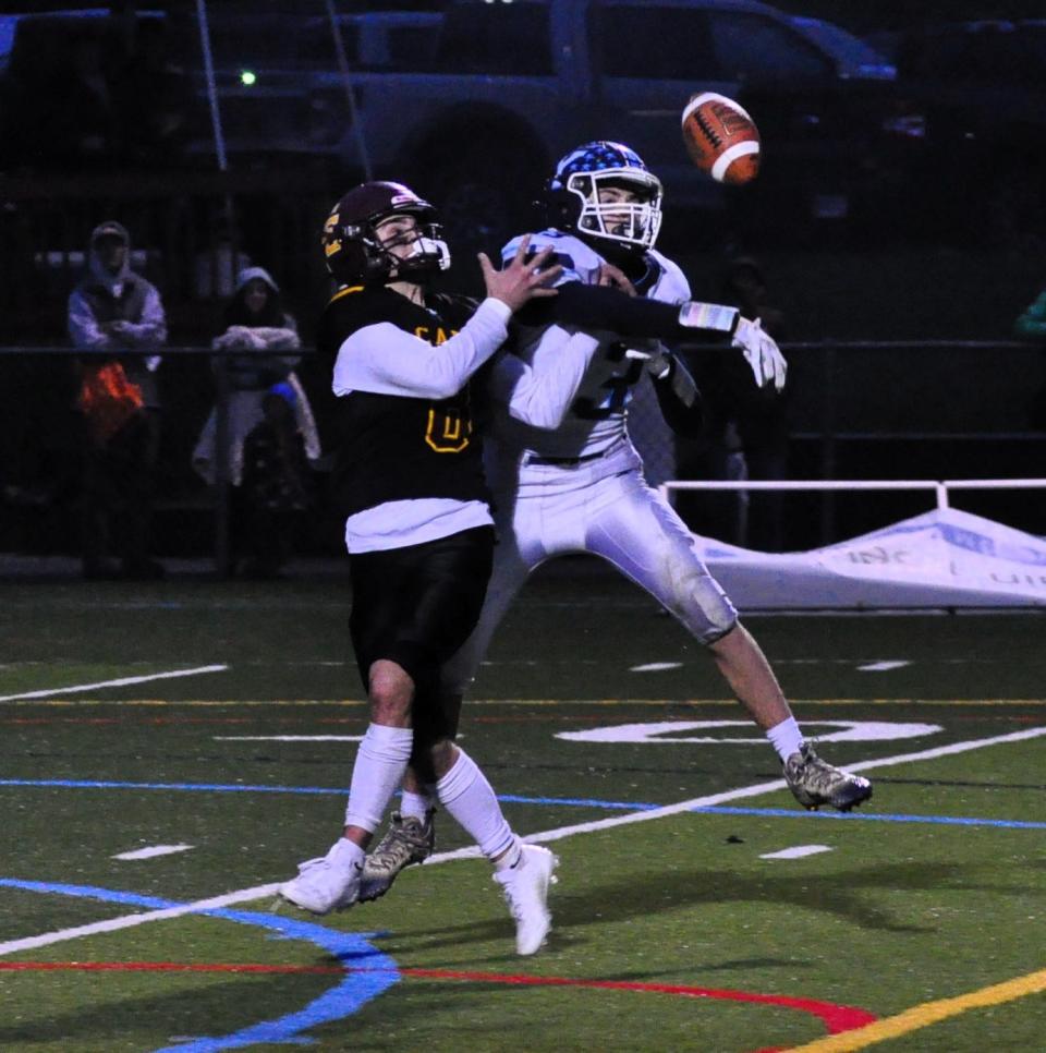 York’s Ben Brown, right, breaks up a pass to Cape Elizabeth’s Logan McVeigh on Monday night