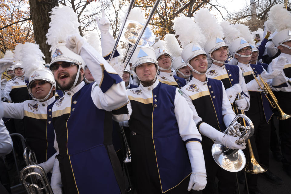 Members of the Western Carolina University marching band cheer as floats go by during the Macy's Thanksgiving Day Parade, Thursday, Nov. 28, 2019, in New York. (AP Photo/Mark Lennihan)