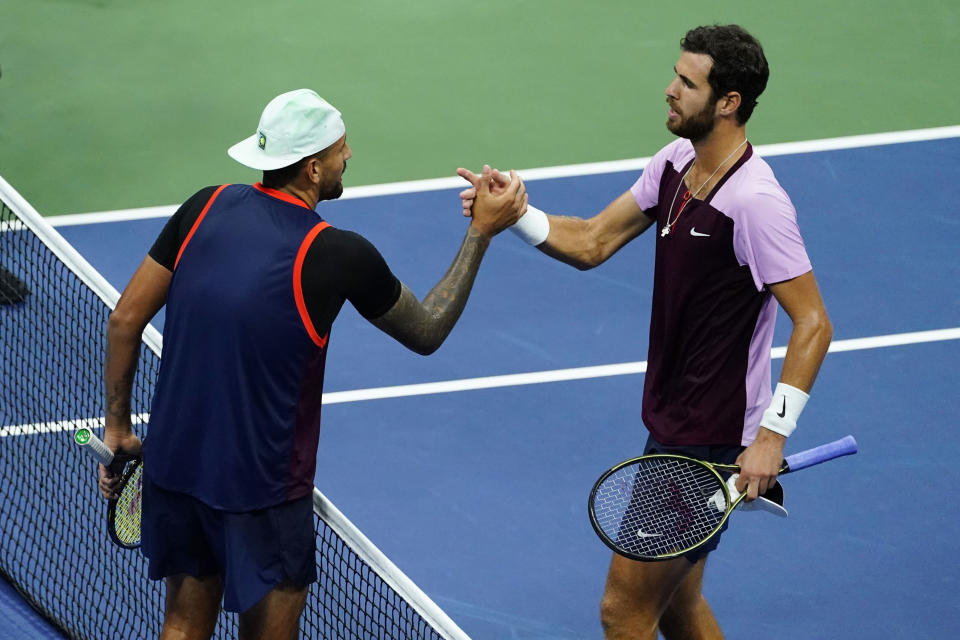 Karen Khachanov, of Russia, right, shakes hands with Nick Kyrgios, of Australia, at the end of a quarterfinal match the U.S. Open tennis championships, Wednesday, Sept. 7, 2022, in New York. Khachanov won the match. (AP Photo/Frank Franklin II)