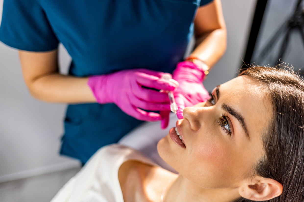 Sideview of Woman Receiving Filler Treatment in Her Lips at a Dermatologist