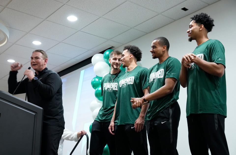 Stetson head basketball coach Donnie Jones speaks with a few of his players behind him during a watch party at the university, Sunday, March 17, 2024.