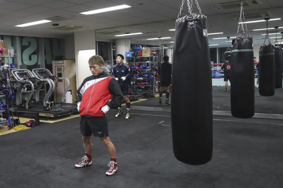 Japanese boxer and the WBA and IBF bantamweight world champion Naoya Inoue warms up before a training session at the Ohashi Boxing Gym in Yokohama, near Tokyo on Nov. 23, 2021. Drawing praise as one of the best "pound for pound" active boxers around, and the best out of Asia since the legendary Manny Pacquiao, Inoue now has his eyes on the big money and American stardom. (AP Photo/Koji Sasahara)