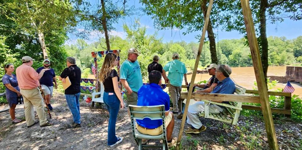 Representatives from a variety of agencies hold a planning meeting at the site of the historic hydroelectric dam on the Pea River, in Elba, Alabama, on June 26, 2023.