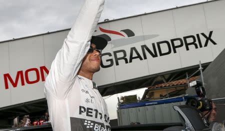 Mercedes Formula One drivers Lewis Hamilton of Britain reacts after taking the pole position of the Monaco Grand Prix in Monaco May 23, 2015. REUTERS/Robert Pratta