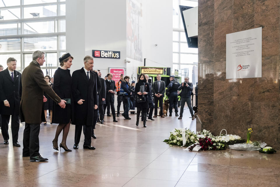 Belgium's King Philippe, center right, and Queen Mathilde, center left, arrive for a one-year anniversary service at Zaventem Airport in Brussels on Wednesday, March 22, 2017. The suicide bombings at the Brussels airport and subway on March 22, 2016, killed 32 people and wounded more than 300 others. (AP Photo/Geert Vanden Wijngaert)