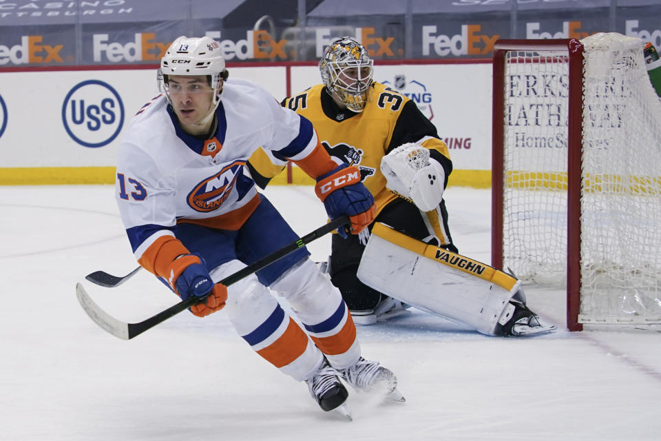 New York Islanders' Mathew Barzal (13) skates away from Pittsburgh Penguins goaltender Tristan Jarry (35) after scoring during the second period of an NHL hockey game Saturday, March 27, 2021, in Pittsburgh. (AP Photo/Keith Srakocic)