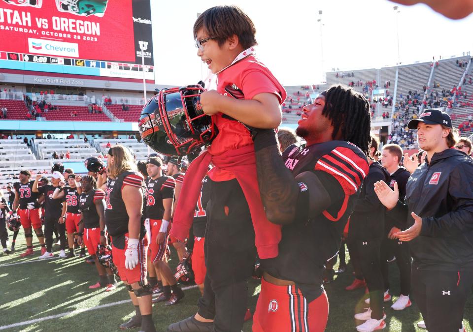 Utah Utes defensive end Chase Kennedy (13) holds Colston Ellis during the fight song in Salt Lake City on Saturday, Oct. 14, 2023. Utah won 34-14. | Jeffrey D. Allred, Deseret News