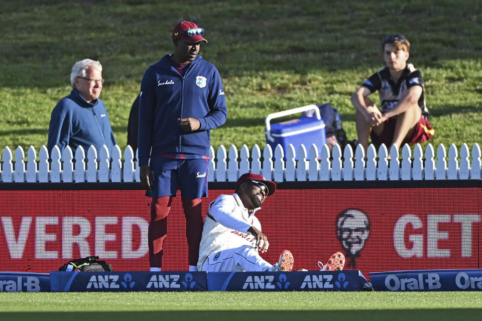 The West Indies Darren Bravo reacts after injuring himself during play on day one of the first cricket test against New Zealand in Hamilton, New Zealand, Thursday, Dec. 3, 2020. (Andrew Cornaga/Photosport via AP)