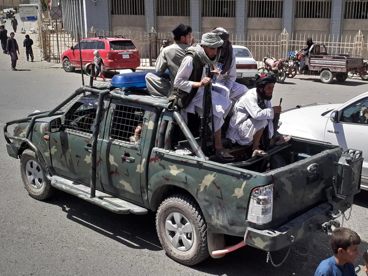 Taliban fighters are pictured in a vehicle of Afghan National Directorate of Security (NDS) on a street in Kandahar on August 13, 2021 (AFP via Getty Images)