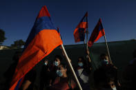 Protesters hold Armenian flags during a demonstration in support of Armenia outside of the U.S. embassy in the Cypriot capital Nicosia, Wednesday, Sept. 30, 2020. Armenian Cypriots took part in the demonstration to show their support to Armenian armed forces locked in heavy fighting with Azerbaijani forces over the separatist region of Nagorno-Karabakh. (AP Photo/Petros Karadjias)