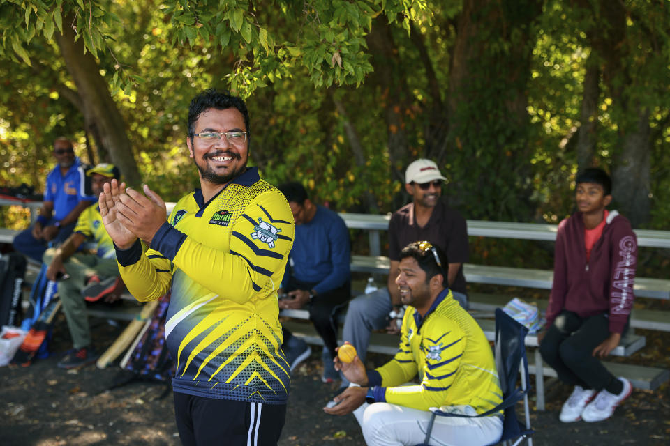 Pavan Kumar Machiraju, left, reacts to a play from the sideline during a cricket match between the Dallas Cricket Connections and the Kingswood Cricket Club on a field adjacent to Roach Middle School in Frisco, Texas, Saturday, Oct. 22, 2022. The teams play in the City of Frisco Cricket league. (AP Photo/Andy Jacobsohn)