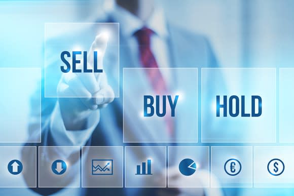 person selecting "sell" from a choice of buy, sell, or hold.