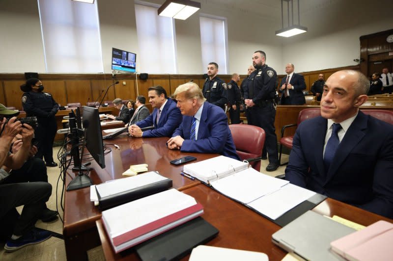 Former President Donald Trump sits with attorney's Todd Blanche (M-L) and Emil Bove (R) as he waits for the start of criminal proceedings on the second day of jury selection at Manhattan criminal court in New York on Tuesday. Pool Photo by Curtis Means/UPI