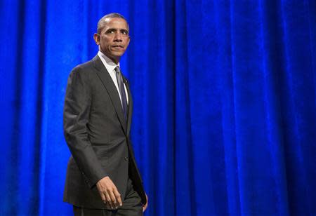 U.S. President Barack Obama walks after delivering remarks at Organizing for Action's "National Organizing Summit" in Washington February 25, 2014. REUTERS/Joshua Roberts