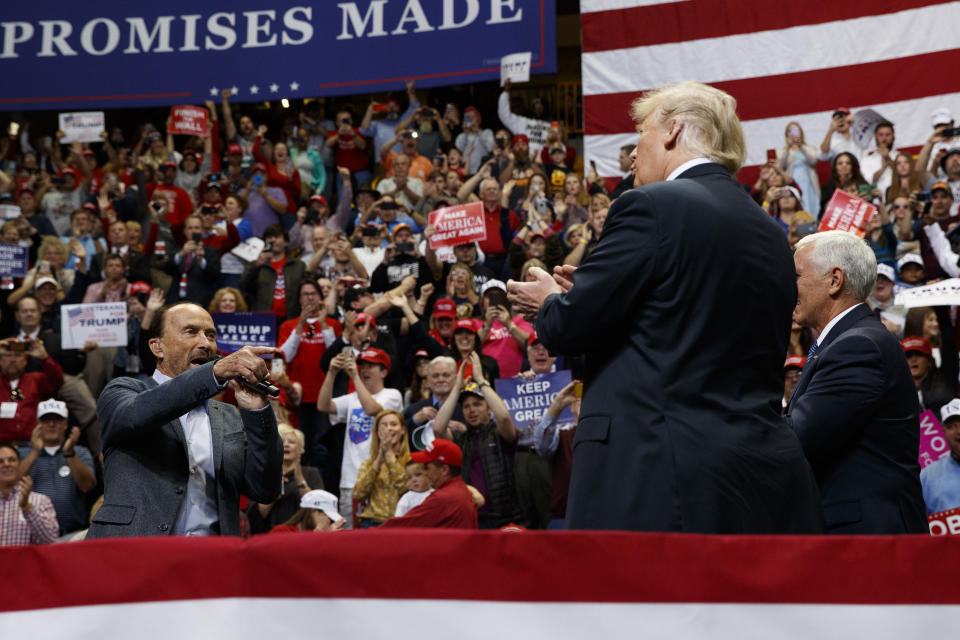 Singer Lee Greenwood points at President Donald Trump and Vice President Mike Pence as he sings during a campaign rally, Sunday, Nov. 4, 2018, in Chattanooga, Tenn. (AP Photo/Evan Vucci)