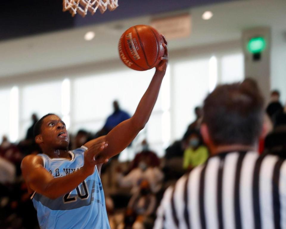 Wyatt guard Marcell McCreary (20) puts in a left handed lay-up during the first half of a Division 5A Region 1 quarterfinal basketball game at Arlington ISD Athletics Complex in Arlington, Texas, Saturday, Feb. 27, 2021. O.D. Wyatt led at the half. (Special to the Star-Telegram Bob Booth)