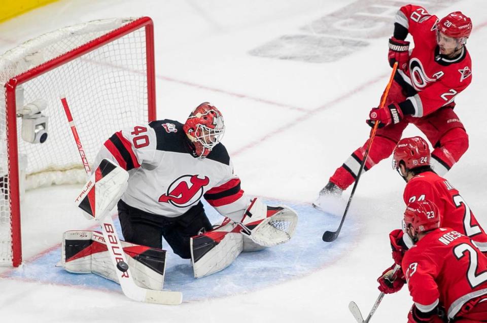 New Jersey Devils goalie Akira Schmid (40) deflects a scoring attempt by the Carolina Hurricanes Sebastian Aho (20) in the third period during Game 5 of their second round Stanley Cup playoff series on Thursday, May 11, 2023 at PNC Arena in Raleigh, N.C.