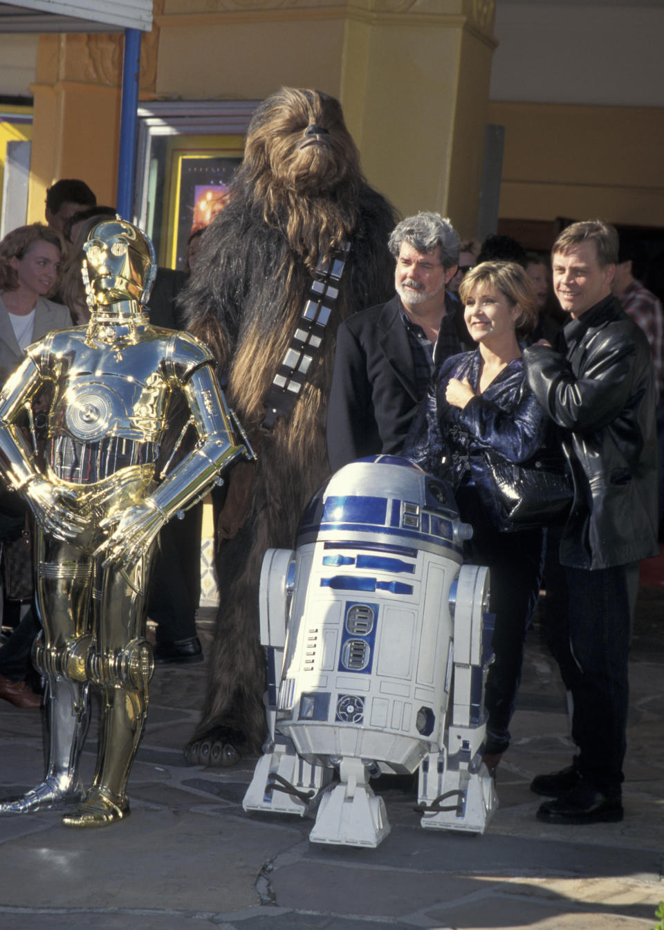 C-3PO, Chewbacca, R2-D2, George Lucas, Carrie Fisher and Mark Hamill.