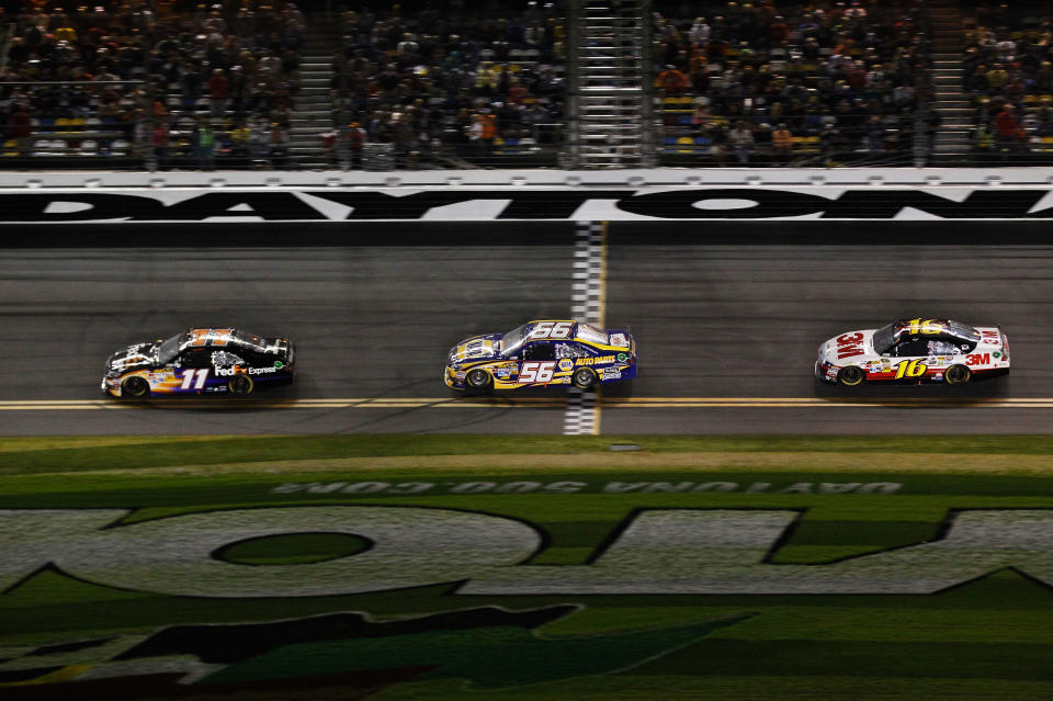 DAYTONA BEACH, FL - FEBRUARY 27: Denny Hamlin, driver of the #11 FedEx Express Toyota, leads Martin Truex Jr., driver of the #56 NAPA Auto Parts Toyota, and Greg Biffle, driver of the #16 3M Ford, during the NASCAR Sprint Cup Series Daytona 500 at Daytona International Speedway on February 27, 2012 in Daytona Beach, Florida. (Photo by Streeter Lecka/Getty Images)