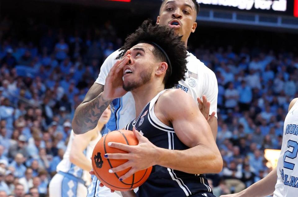 Duke’s Jared McCain (0) drives by North Carolina’s Armando Bacot (5) during the second half of UNC’s 93-84 victory over Duke at the Smith Center in Chapel Hill, N.C., Saturday, Feb. 3, 2024.