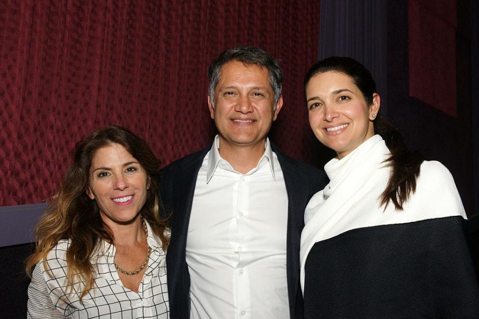 Joe Kiani stands between Nicole Boxer and Sarah Kiani, smiling.