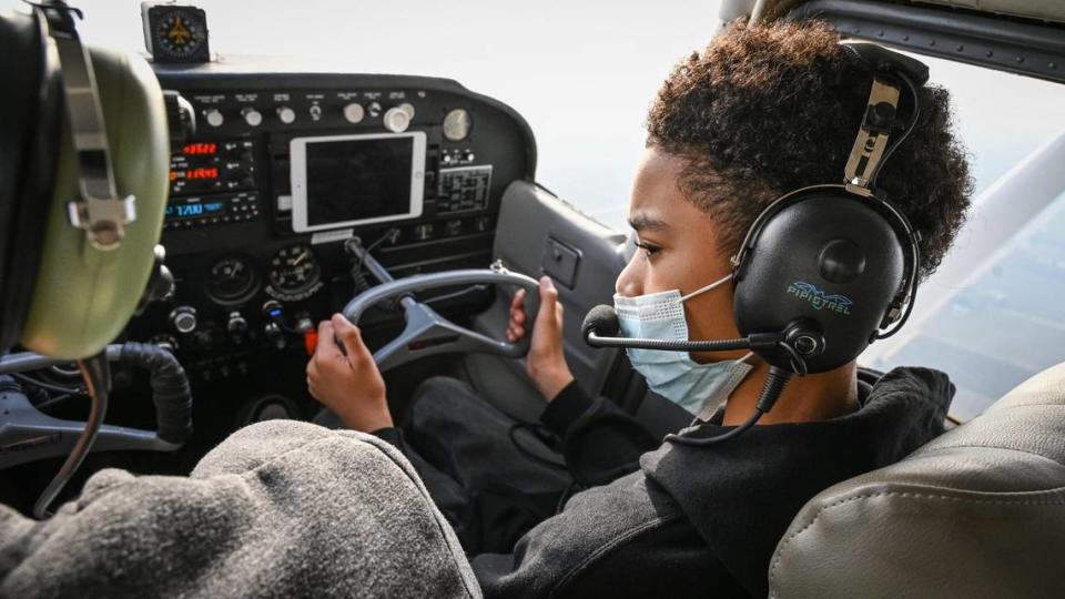 Sammy Taylor, 12, takes the controls of a single-engine airplane he’s been learning to fly in with instructor Joseph Oldham during a flight out of Fresno Chandler Airport on Wednesday, Jan. 13, 2022.