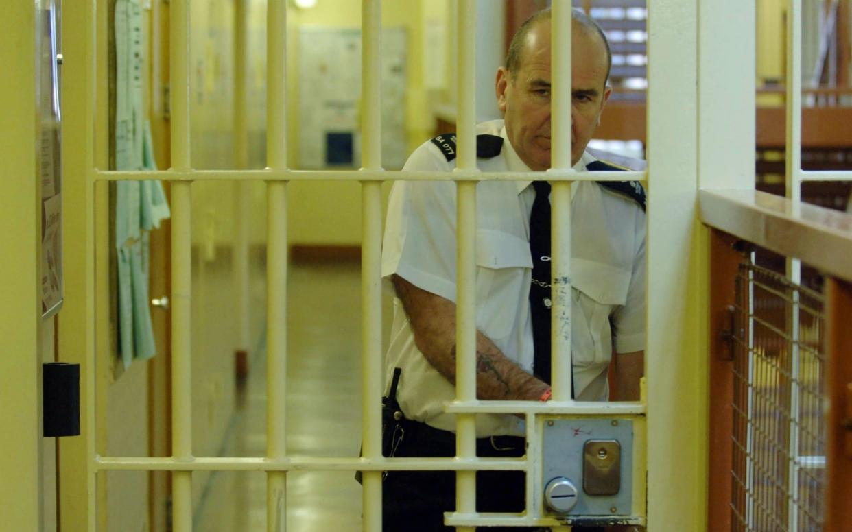 A prison officer locks a door at Belmarsh maximum security jail in south east London - Stefan Rousseau//PA