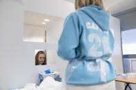 A student at Great Academy Ashton is taken through the Covid testing proceedure as the school prepares for its reopening on March 8 after the latest lockdown curb the spread of coronavirus, in Ashton-Under-Lyne, England, Thursday, March 4, 2021. The school for approximately 1300 pupils aged 11 to 16 in Greater Manchester will have to conduct around 450 tests per day on pupils and staff in the first 2 weeks after the return of students on Monday. (AP Photo Jon Super)