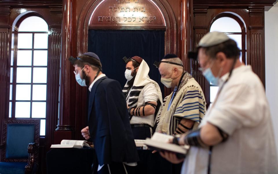 Rabbi Levi Duchman, centre, and members of the congregation pray ahead of Rosh Hashanah, the Jewish New Year, at the only known synagogue in the Arabian Peninsula - Christopher Pike 