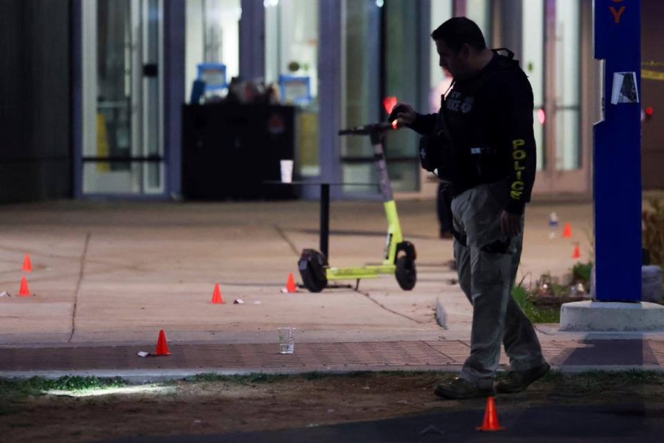 A police officer searches for evidence in front of a building at Morgan State Universit (Copyright 2023 The Associated Press. All rights reserved.)