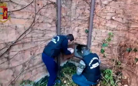 Police show the metal panel where the Klimt painting was apparently found  - Credit: Italian Police