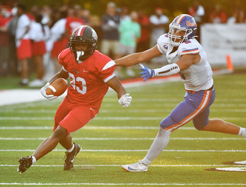 Aliquippa's Tiqwai Hayes escapes Armstrong's Isaiah Brown during Friday night's game at Aliquippa's new stadium, Heinz Field.