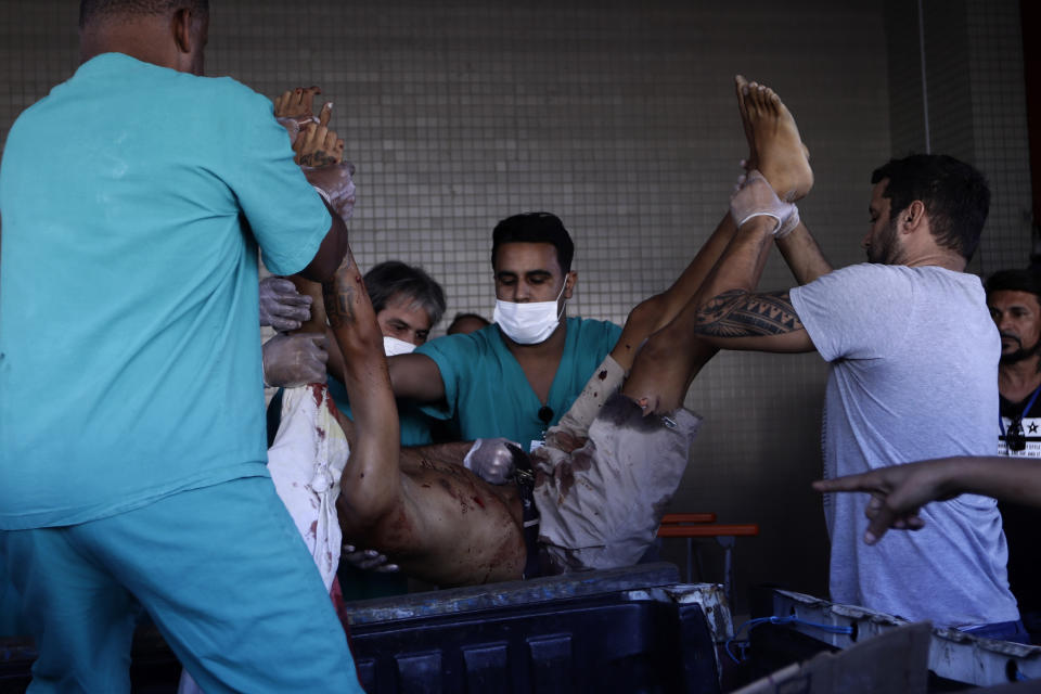 A person wounded during a police raid of the Vila Cruzeiro favela is placed on a gurney at the Getulio Vargas Hospital, in Rio de Janeiro, Brazil, Tuesday, May 24, 2022. Police raided the favela before dawn Tuesday in an operation aimed at locating and arresting criminal leaders, prompting a fierce firefight. (AP Photo/Bruna Prado)