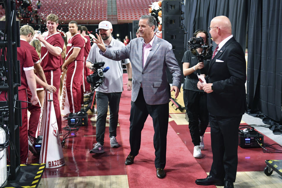 John Calipari waves to Arkansas fans as he leaves the stage after being introduced men's basketball coach Wednesday, April 10, 2024, in Fayetteville, Ark. (AP Photo/Michael Woods)