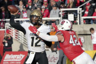 Colorado quarterback Brendon Lewis (12) throws a pass as he is pressured by Utah defensive end Mika Tafua (42) in the first half of an NCAA college football game Friday, Nov. 26, 2021, in Salt Lake City. (AP Photo/George Frey)