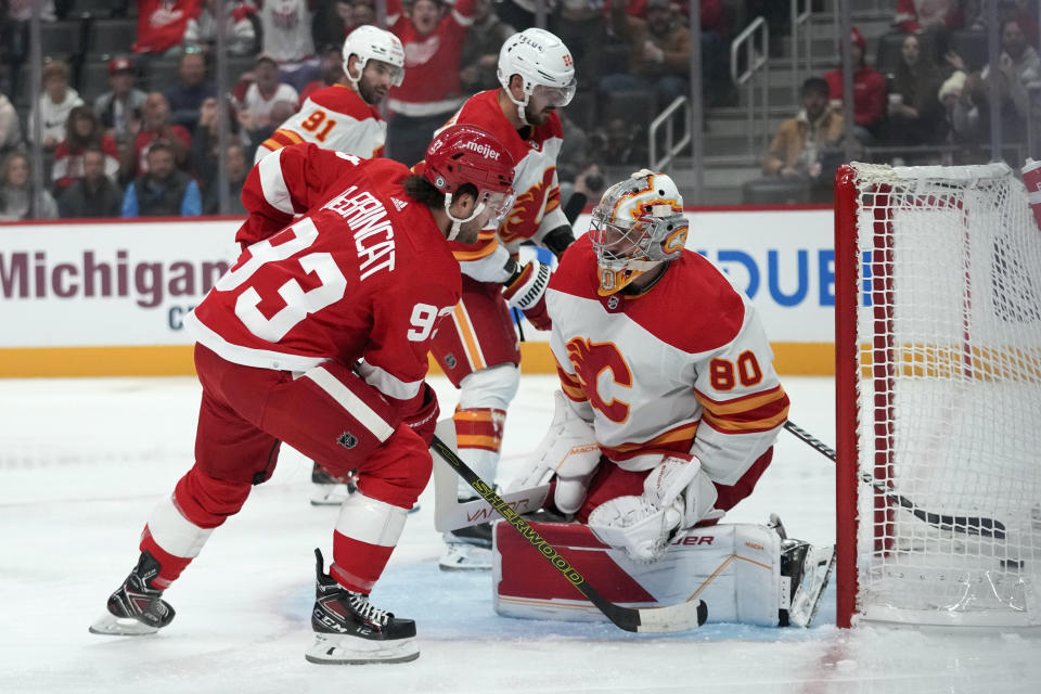 Detroit Red Wings right wing Alex DeBrincat (93) scores on Calgary Flames goaltender Dan Vladar (80) in the first period of an NHL hockey game Sunday, Oct. 22, 2023, in Detroit. (AP Photo/Paul Sancya)