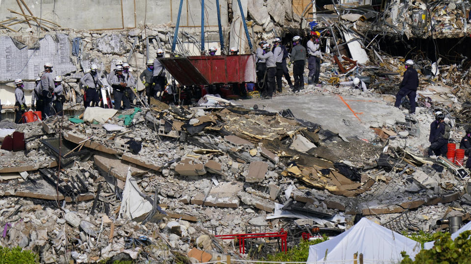 Workers search the rubble at the Champlain Towers South Condo, Monday, June 28, 2021, in Surfside, Fla. Many people were still unaccounted for after Thursday's fatal collapse. (AP Photo/Lynne Sladky)