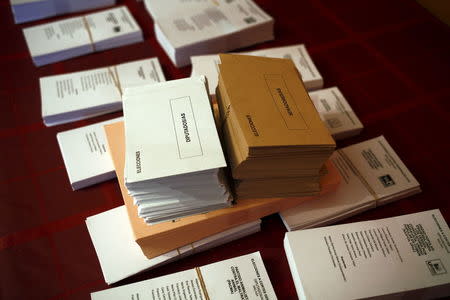 Ballots and envelopes are seen on a table inside a house prepared as a polling station ahead of Spain's general election in Puerto Sauco, a small hamlet near the city of Ronda, southern Spain, December 19, 2015. REUTERS/Jon Nazca