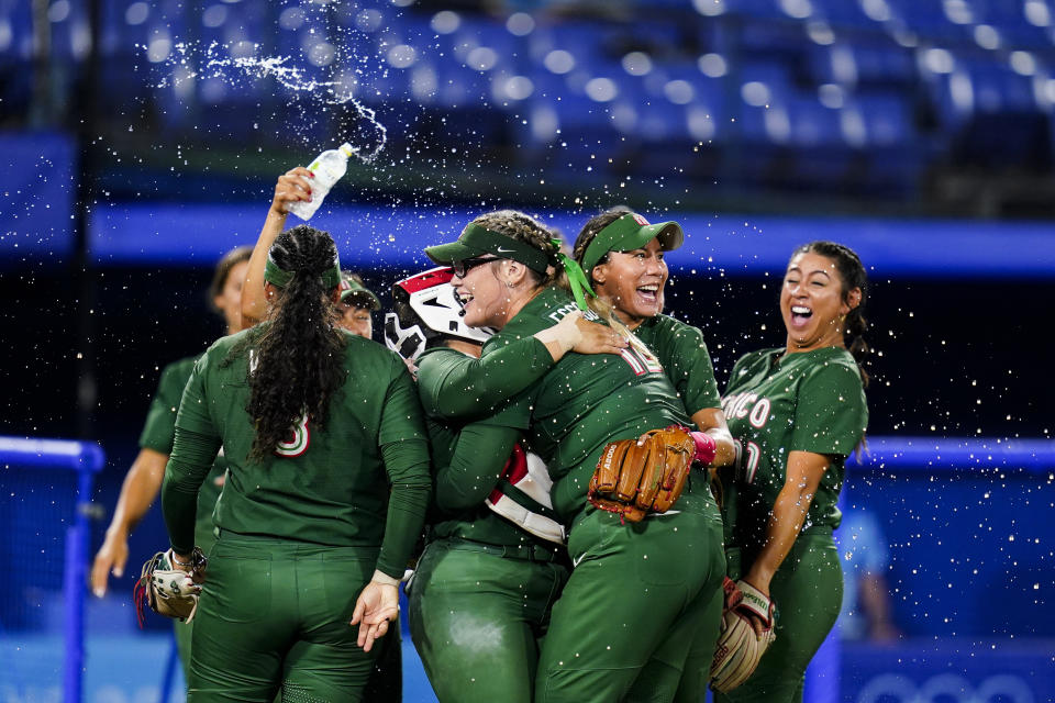 Mexico's Dallas Escobedo, center, celebrate with teammates after pitching a complete softball game against Italy at the 2020 Summer Olympics, Sunday, July 25, 2021, in Yokohama, Japan. (AP Photo/Matt Slocum)