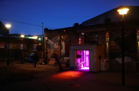 Dawn lights the sky behind nightclub Crack Bellmer in the RAW area of Berlin, Germany, September 6, 2016. Night after night thousands of Berliners and visitors head to hotspots like RAW, an old graffiti-covered train-repair site in the eastern part of the city that was once under Communist rule but is now home to clubs, bars and a pool replete with beer garden. REUTERS/Hannibal Hanschke