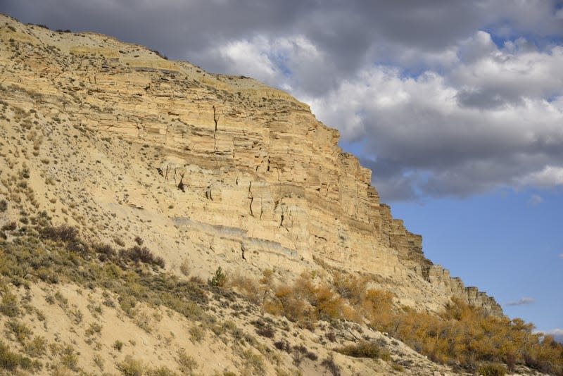 A large cliff in the national monument. - Photo: <a class="link " href="https://commons.wikimedia.org/wiki/File:Fossil_Butte_Member_Type_Section.jpg#/media/File:Fossil_Butte_Member_Type_Section.jpg" rel="nofollow noopener" target="_blank" data-ylk="slk:Wikimedia Commons;elm:context_link;itc:0;sec:content-canvas">Wikimedia Commons</a>