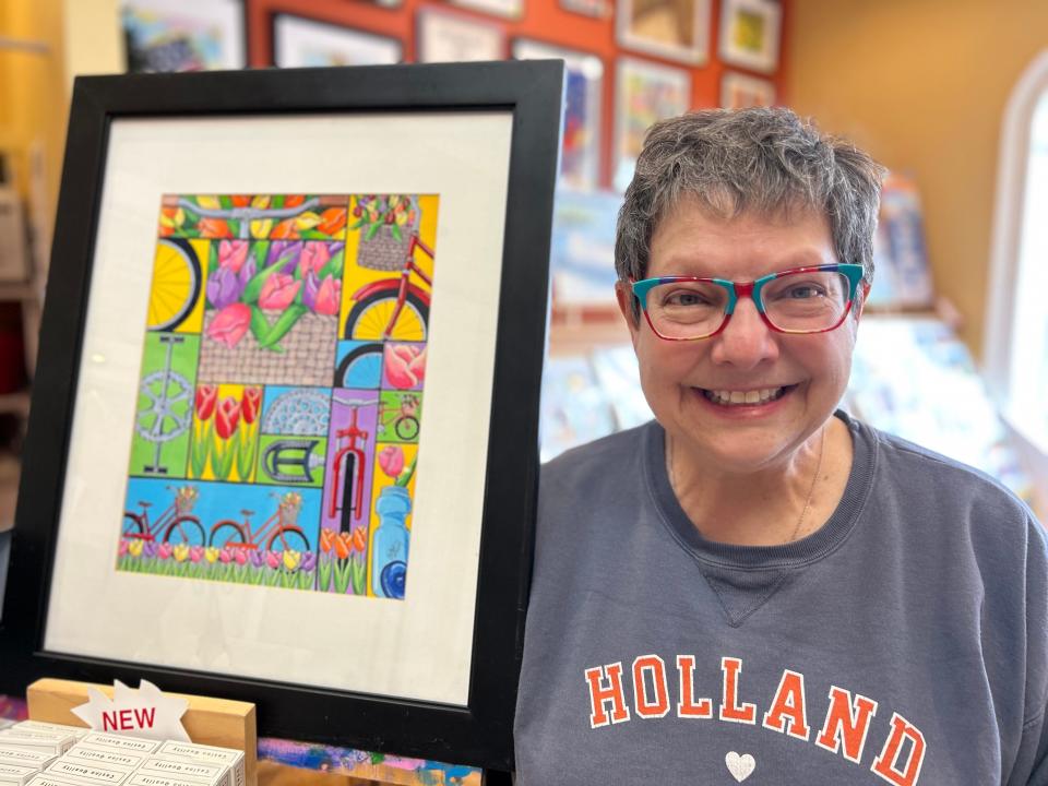 Carolyn Stich poses next to her artwork in downtown Holland on Wednesday, Feb. 28.