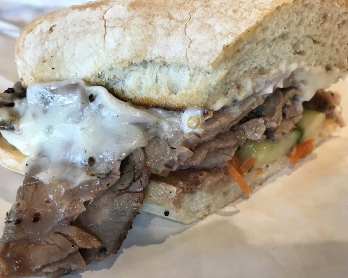 Closeup of Asian Flank Steak Sandwich on white serving paper, Mitchell Delicatessen, Nashville