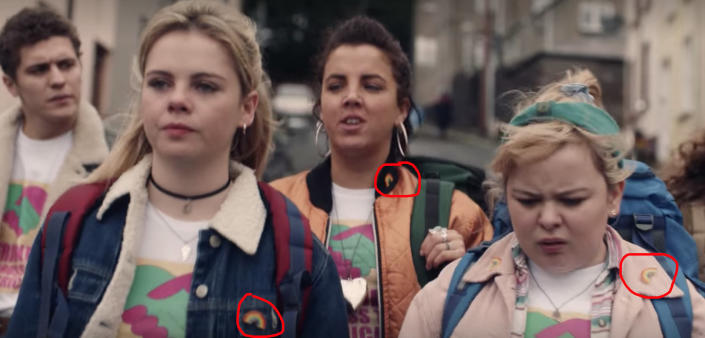 The Derry Girls all wearing rainbow pins