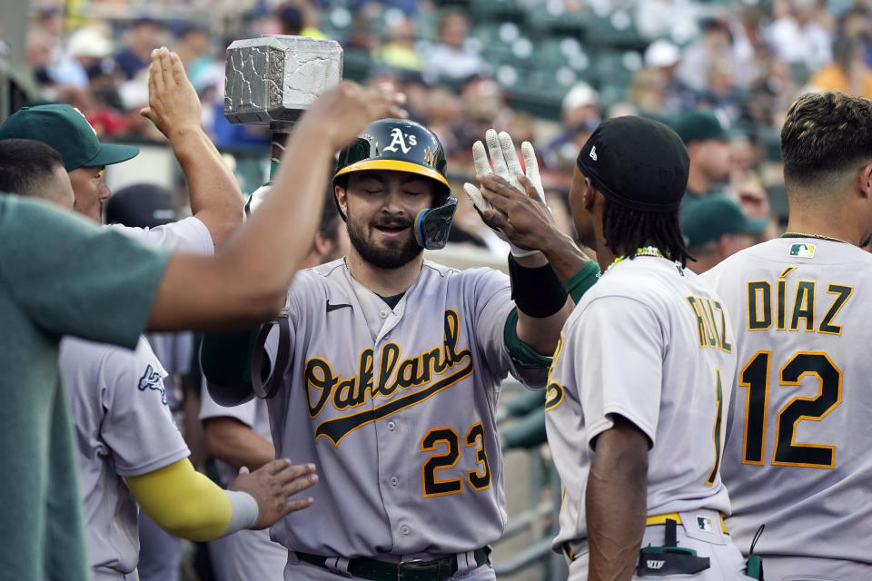 Oakland Athletics' Shea Langeliers is greeted in the dugout after his solo home run during the fourth inning of a baseball game against the Detroit Tigers, Wednesday, July 5, 2023, in Detroit. (AP Photo/Carlos Osorio)