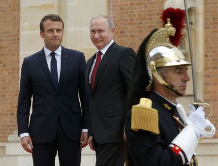 French President Emmanuel Macron (L) meets with Russian President Vladimir Putin at the Chateau de Versailles near Paris, France, May 29, 2017. REUTERS/Alexander Zemlianichenko/Pool