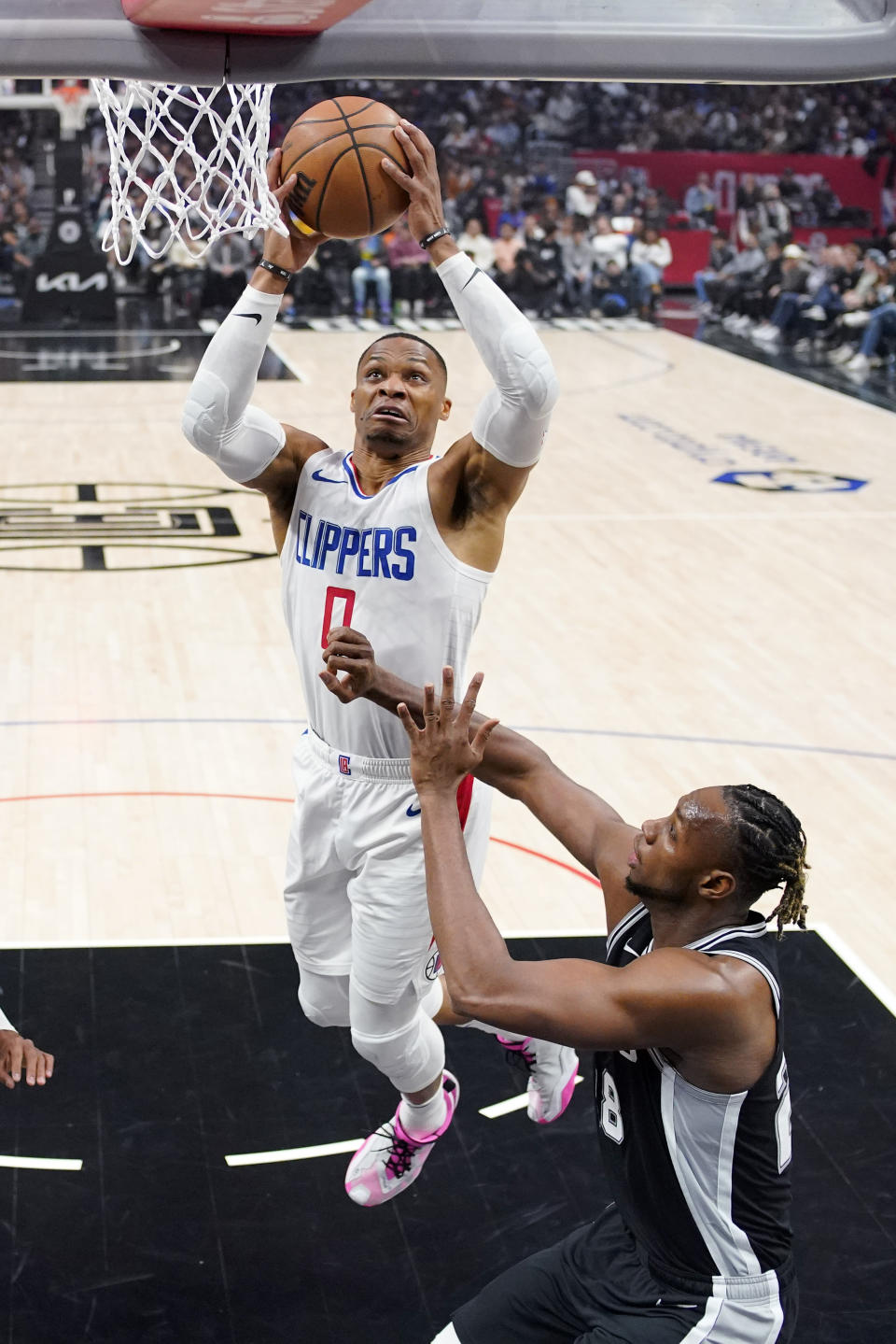 Los Angeles Clippers guard Russell Westbrook,left, shoots as San Antonio Spurs center Charles Bassey defends during the first half of an NBA basketball game Sunday, Oct. 29, 2023, in Los Angeles. (AP Photo/Mark J. Terrill)