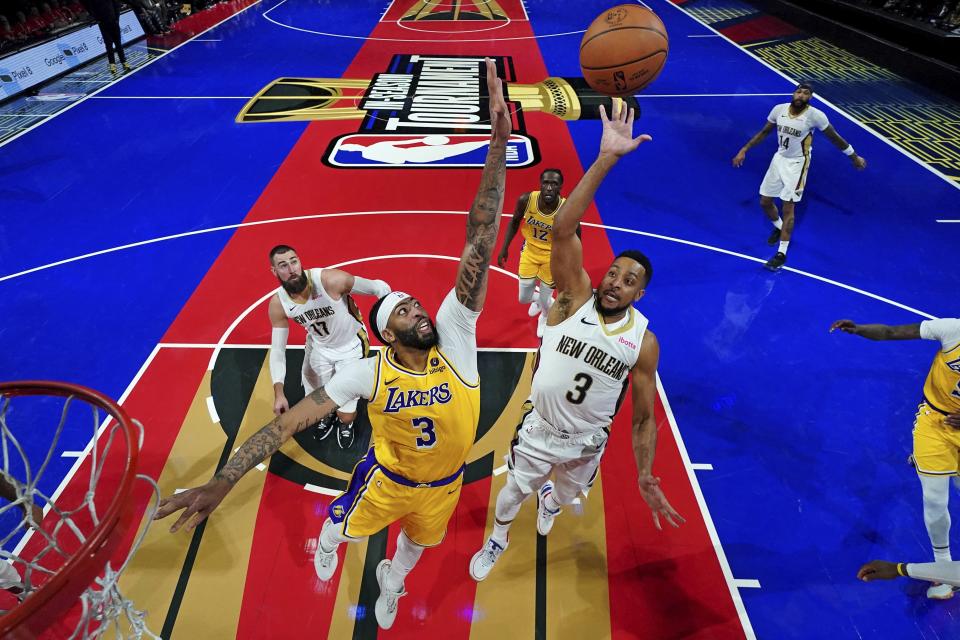 New Orleans Pelicans guard CJ McCollum, right, shoots the ball against Los Angeles Lakers forward Anthony Davis during a semifinal game in the NBA basketball In-Season Tournament, Thursday, Dec. 7, 2023, in Las Vegas. (Kyle Terada/Pool Photo via AP)