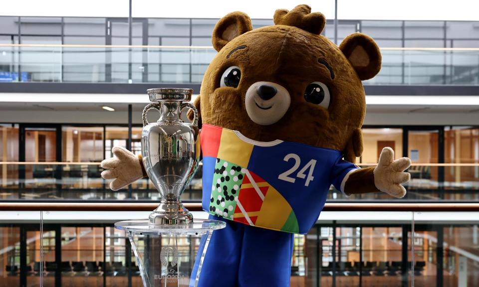 <span>The Euro 2024 trophy is seen at Hans-Sachs-Haus, town hall of Gelsenkirchen, along with tournament mascot Albärt.</span><span>Photograph: Christof Köpsel/Uefa/Getty Images</span>