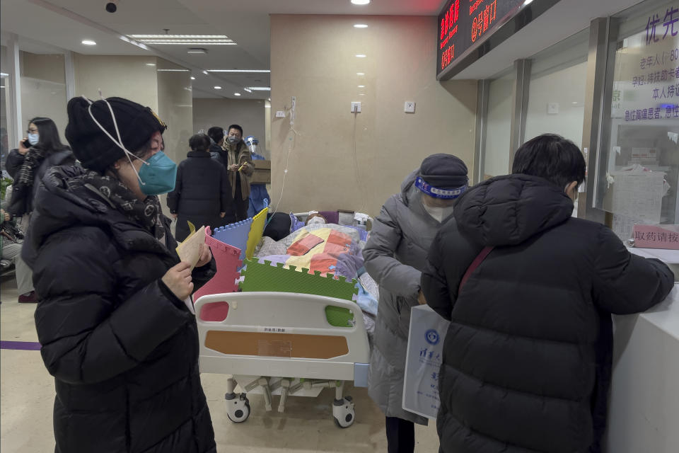 An elderly patient rests near a medicine collection counter as people wait in the emergency ward of a hospital in Beijing, Thursday, Jan. 5, 2023. Patients, most of them elderly, are lying on stretchers in hallways and taking oxygen while sitting in wheelchairs as COVID-19 surges in China's capital Beijing. (AP Photo/Andy Wong)